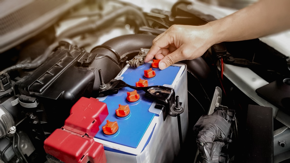 Checking Car Battery On Car Engine 